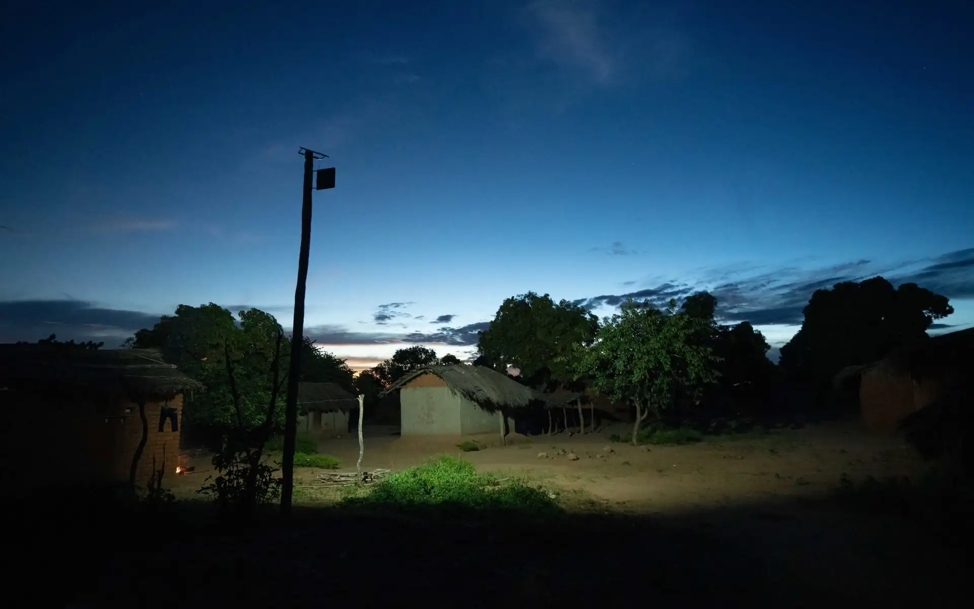 Lazaro Village at blue hour, a solar light on a pole lighting the ground between homes