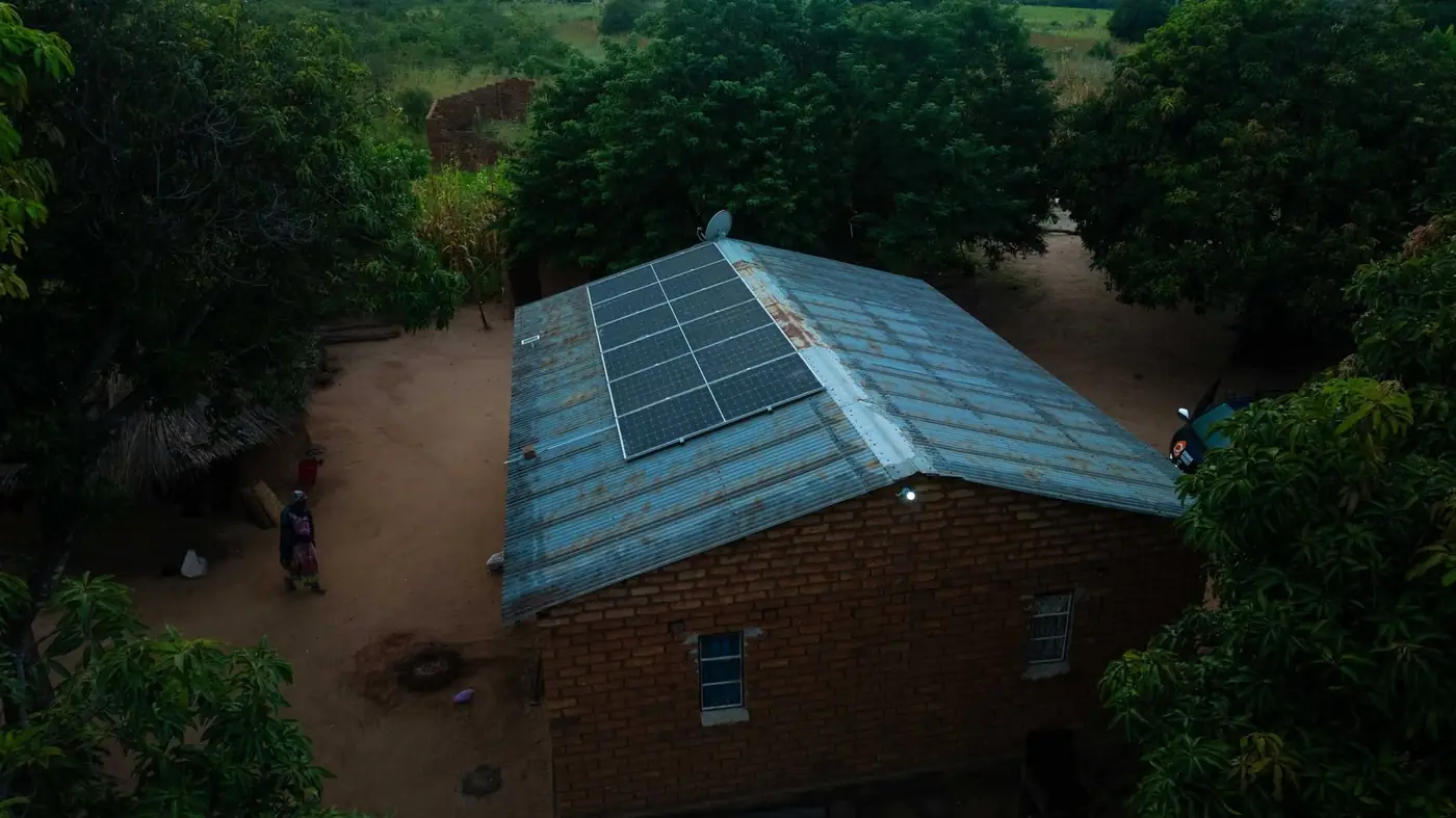 Drone view at dusk of a Lazaro Village home with solar panels on its roof
