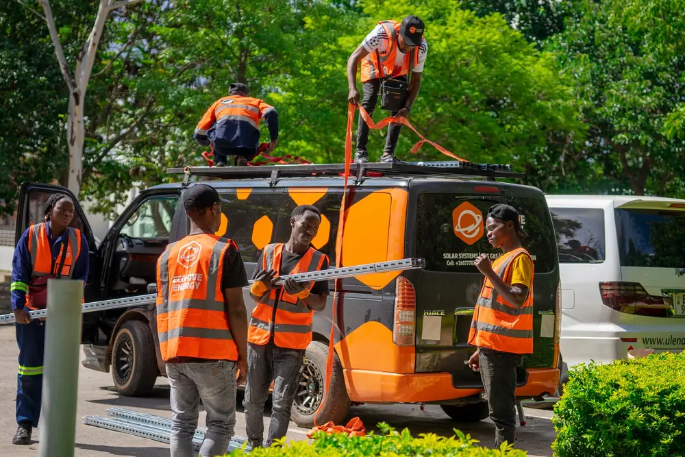 The EcoHive crew unloading mounting rails from the company van